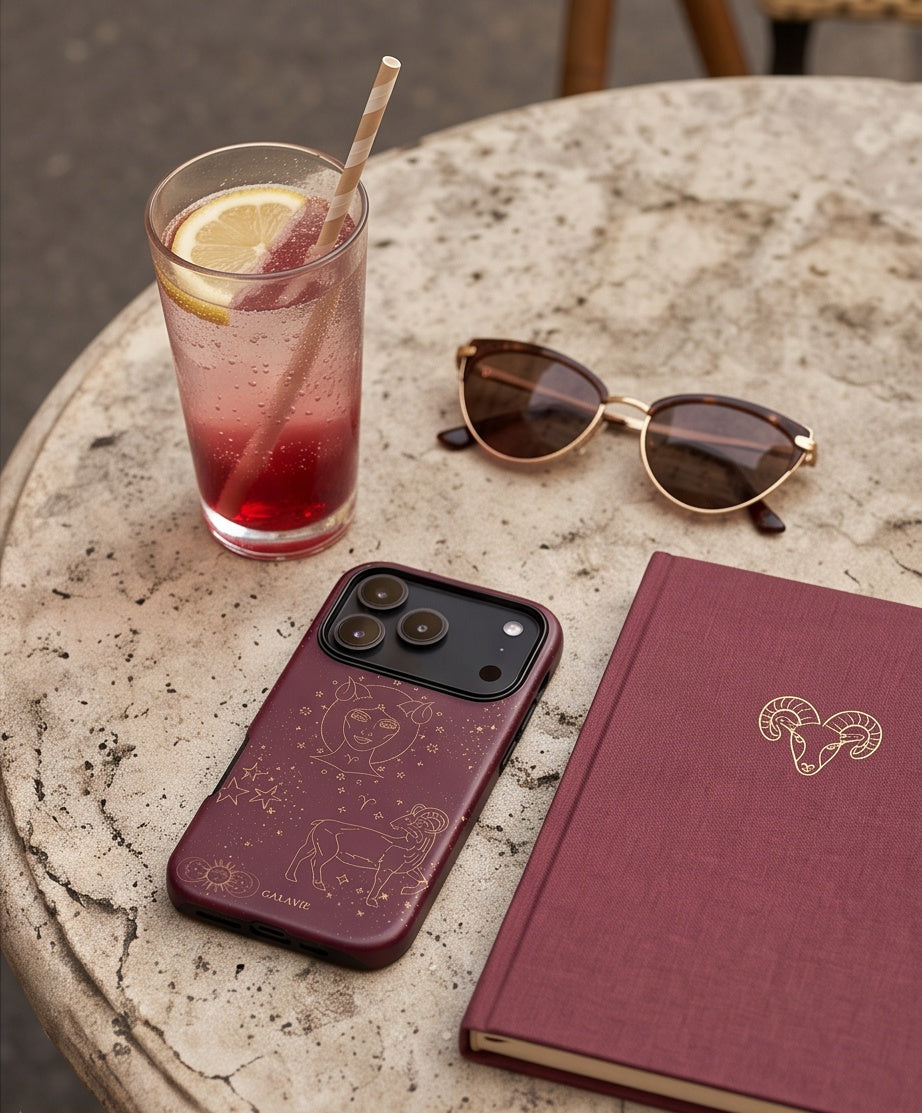Aries Zodiac Phone Case in Merlot on a café table, lifestyle photo